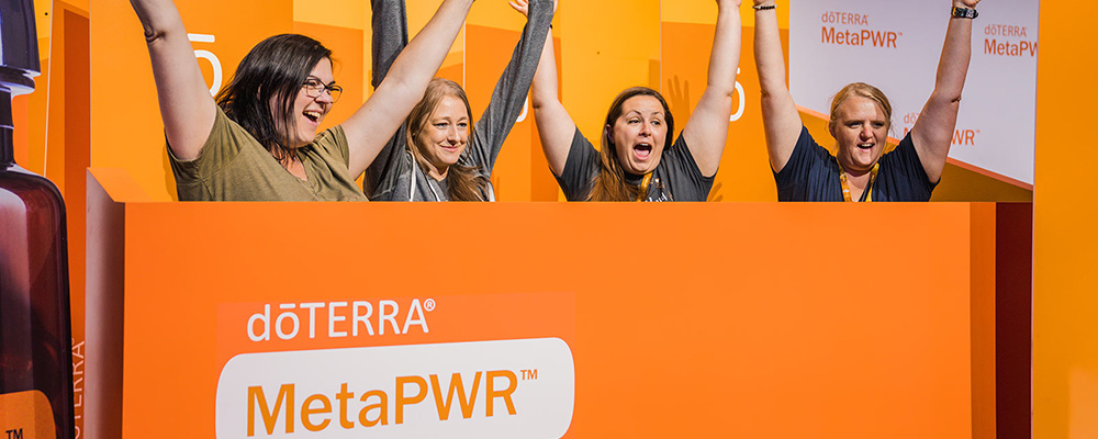 Group of people cheering in an orange seating section.