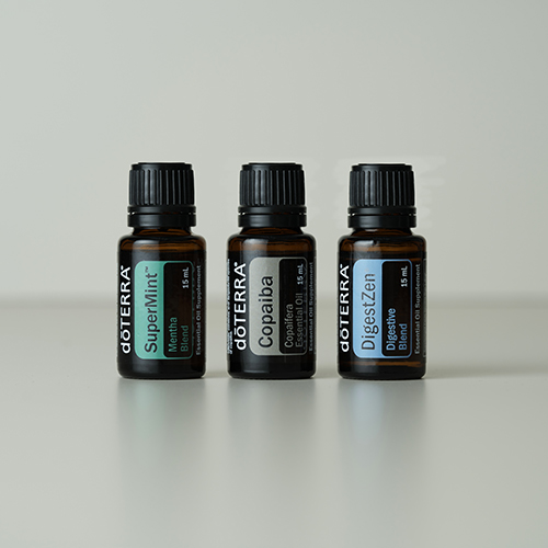 SuperMint, Copaiba, and DigestZen bottles standing next to each other with a white background.