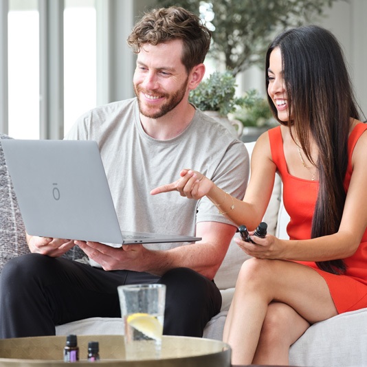 people at a laptop sharing oils
