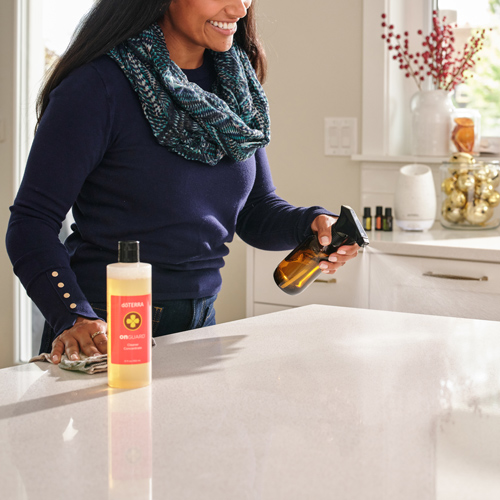 A woman using on guard concentrade cleaner in a spray bottle