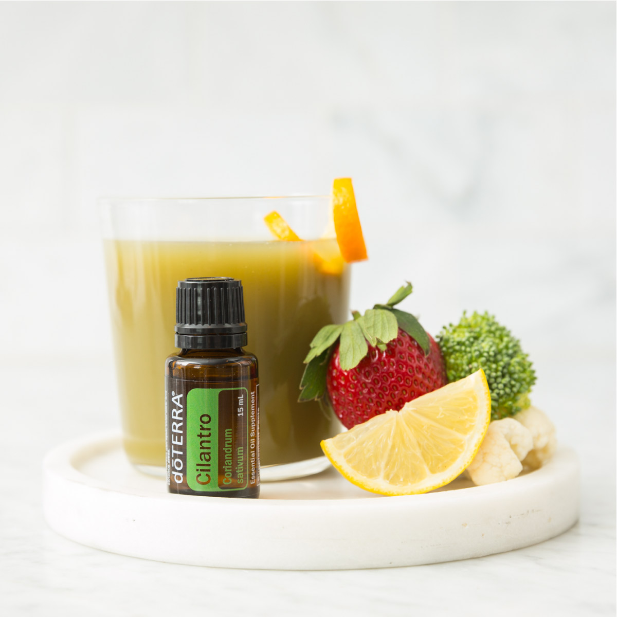 Bottle of Cilantro essential oil with healthy smoothie and slices of fresh fruit. Can you ingest Cilantro oil? Cilantro essential oil can be ingested when a safe amount is added to food or diluted in at least four ounces of liquid.