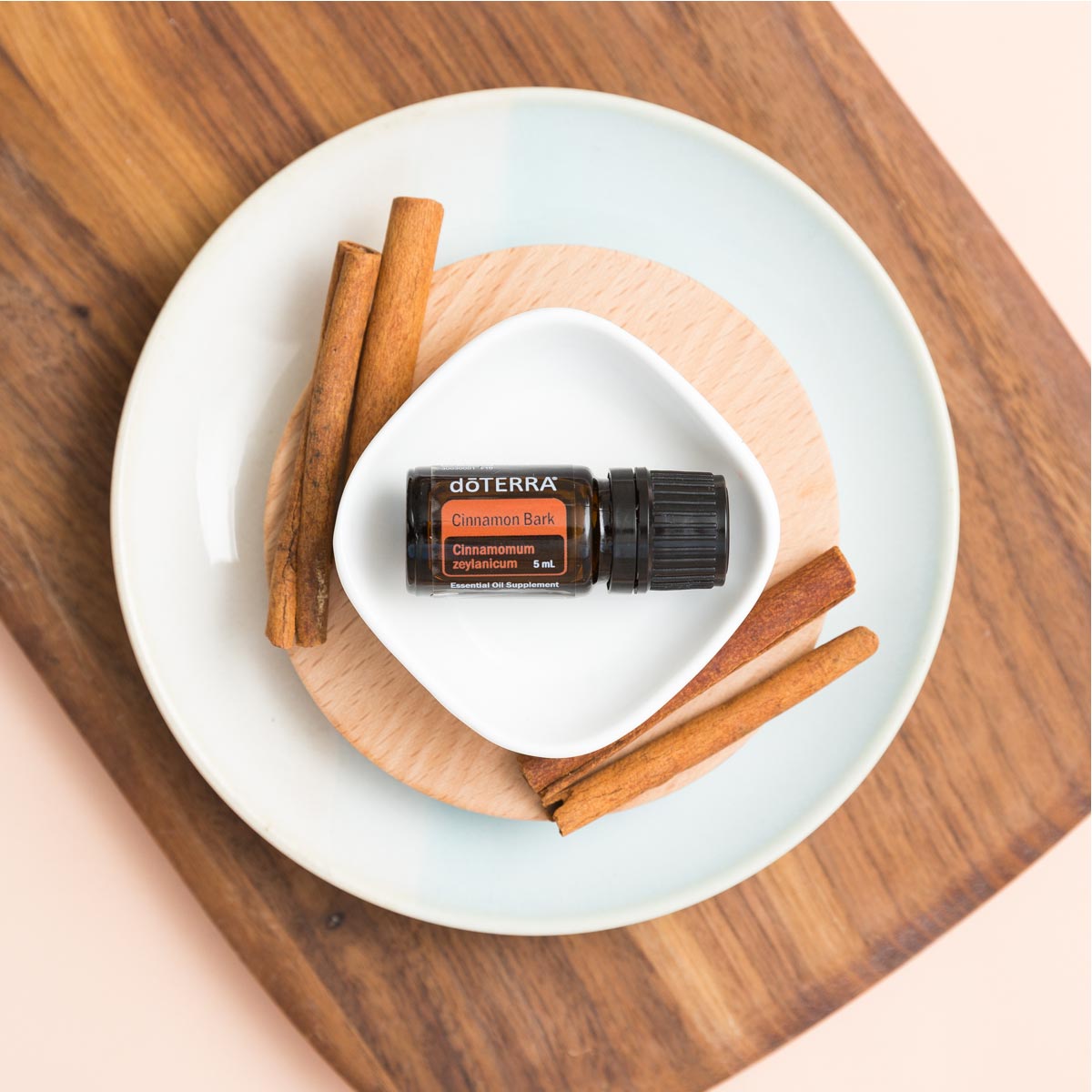 Cinnamon essential oil bottle on a plate next to fresh cinnamon spices. Can you eat Cinnamon oil? When used in appropriate amounts, Cinnamon essential oil can be used in cooking to flavor food and beverages.