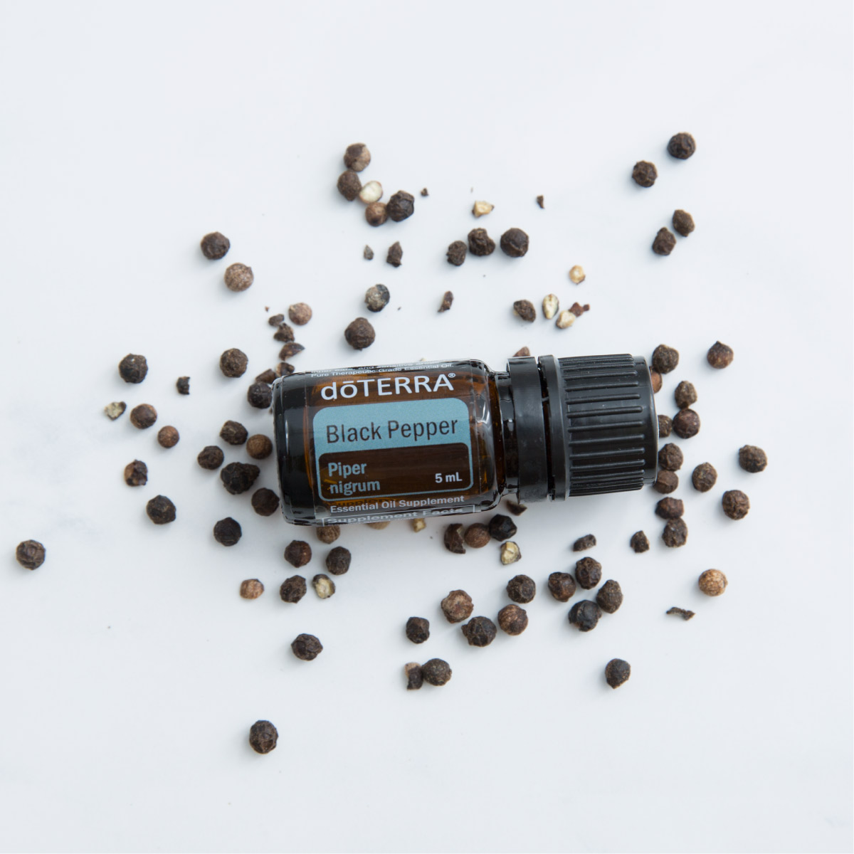 Black Pepper essential oil bottle with fruit from a black pepper plant. How is Black Pepper essential oil made? Black Pepper essential oil is made by steam distilling the fruit of the Piper nigrum plant.
