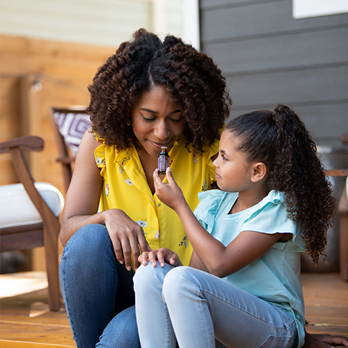 Mother and daughter with doTERRA's lavender essential oil.