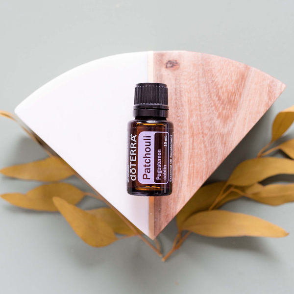 Patchouli essential oil bottle, block of wood, yellow leaves. What is Patchouli oil good for? Patchouli essential oil is commonly used for skin care, oral care, or as a personal fragrance.
