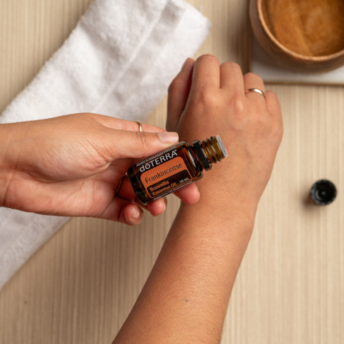 Woman applying Frankincense oil to her arm. Is it safe to use Frankincense oil on the skin? Yes, Frankincense essential oil can be used to improve the appearance of skin.