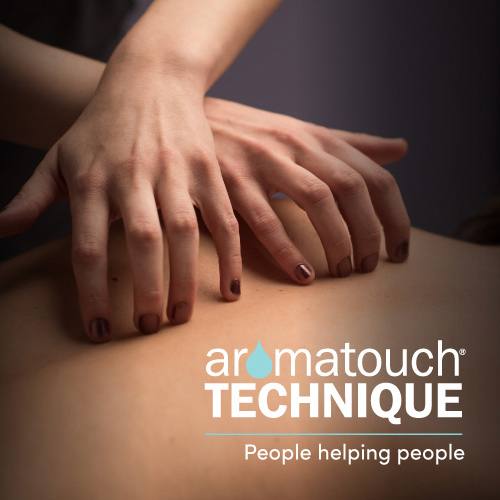 Hands applying AromaTouch Technique