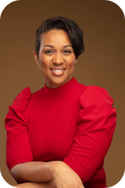 A formal photo of doTERRA Scientific and Medical Education Committee Member Dr. Ashley Anderson posing in a red shirt with a brown background.