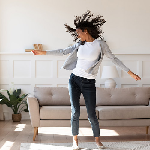 A woman dancing in her living room