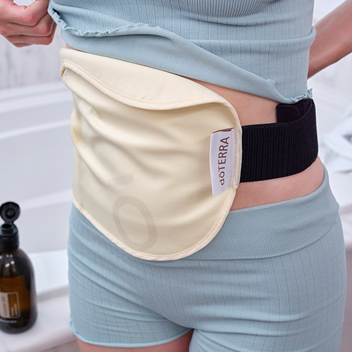 A woman with a heating pad on her belly