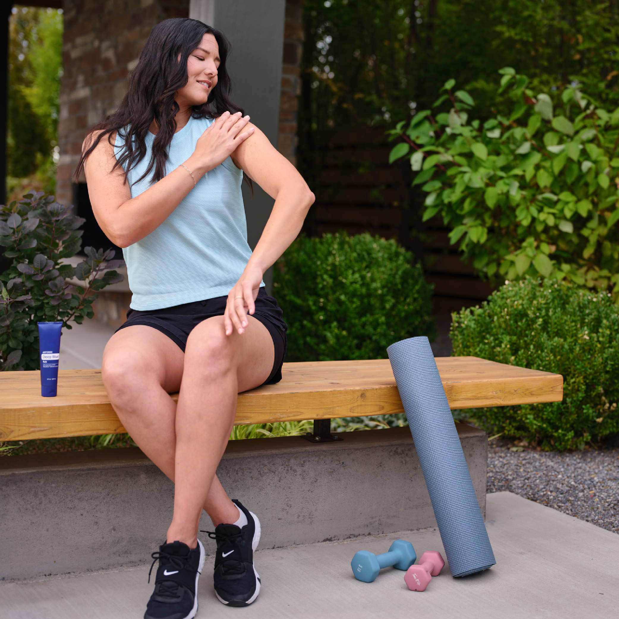 Woman applying deep blue to shoulder