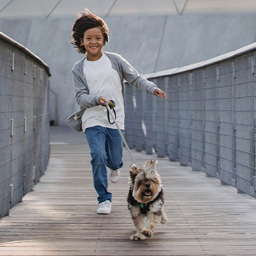 Boy running with his dog