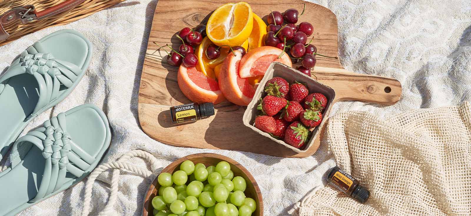 Wood cutting board with fruits and Essential Oils on the side