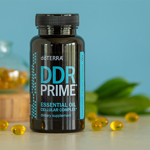 A bottle of doTERRA DDR Prime with softgel capsules in the foreground