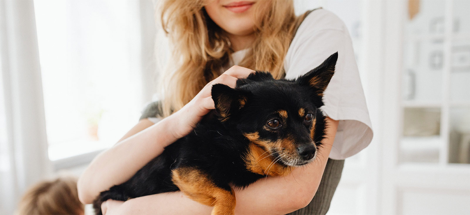 Woman holding her dog