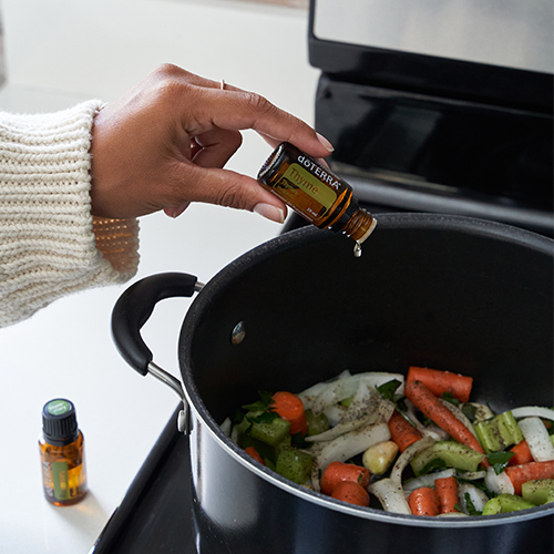 Woman cooking using essential oils