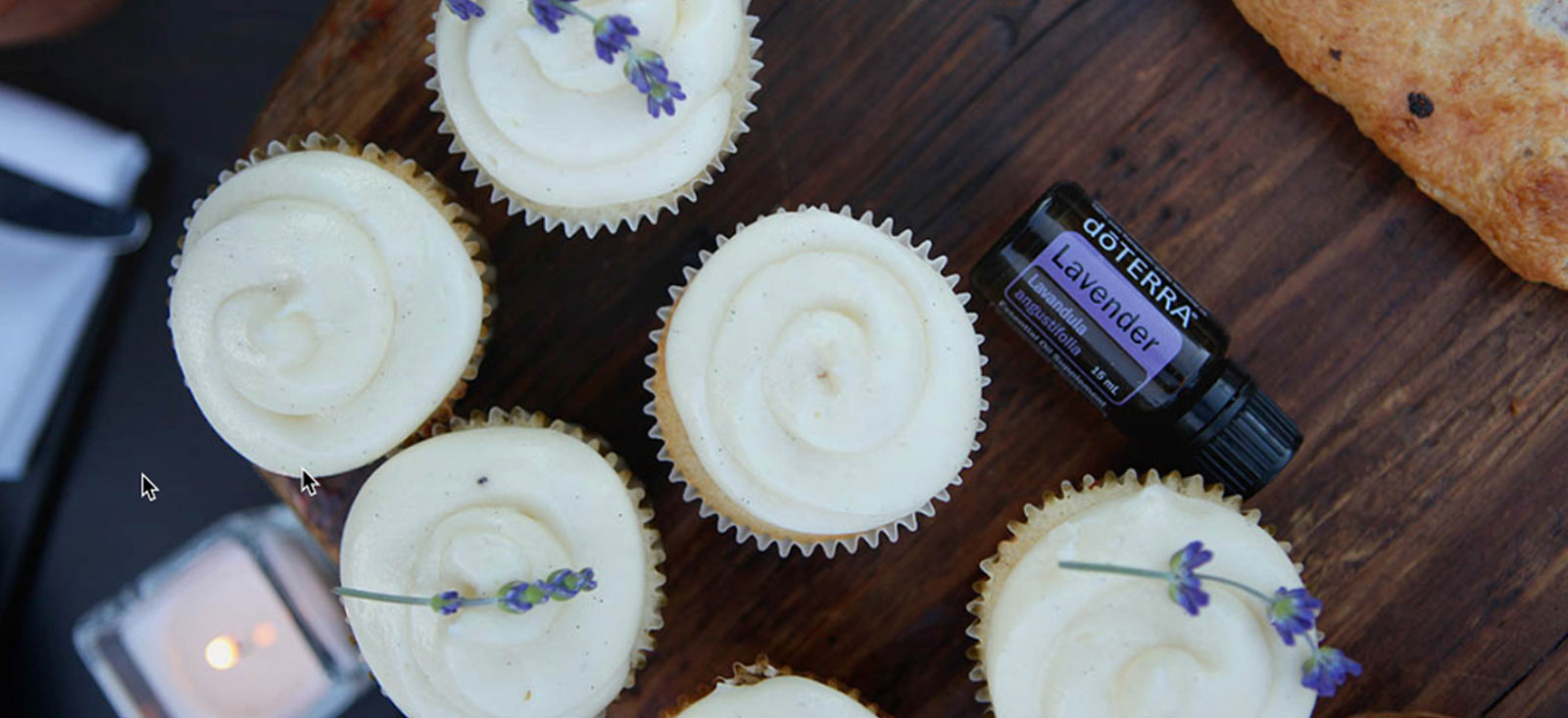 A tray of cupcakes with doTERRA Lavender Essential Oil on a wooden table