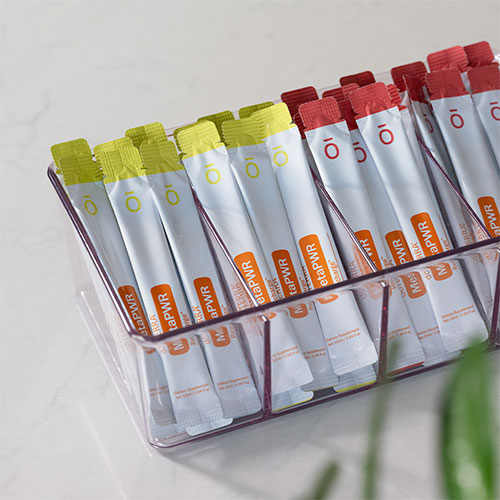 A clear tray is filled with doTERRA MetaPWR Recharge sachets.