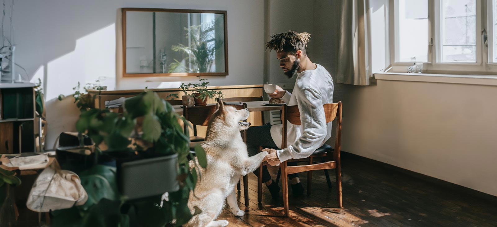 A man sitting at a table with a dog