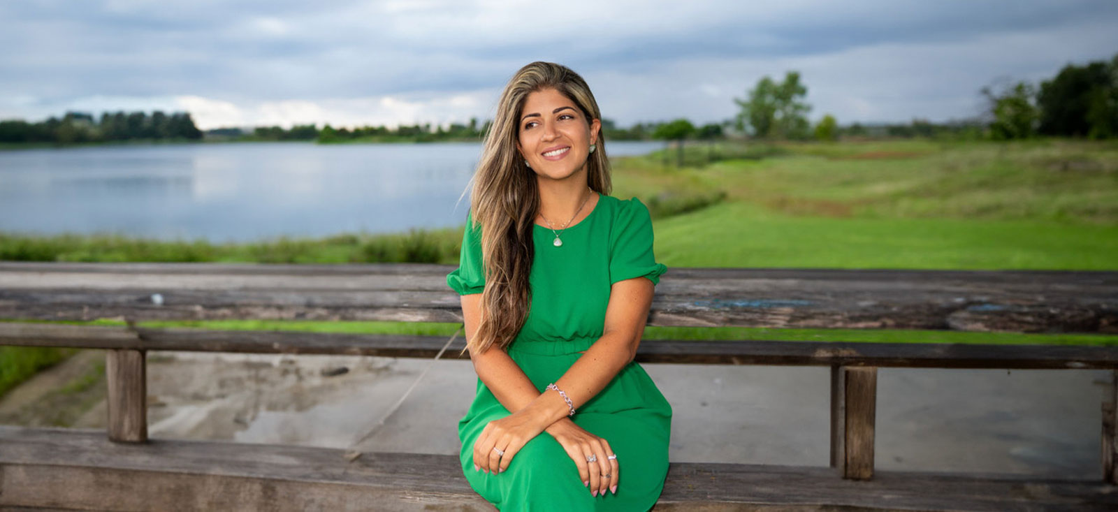 Renata Rivera is sitting on a bench.