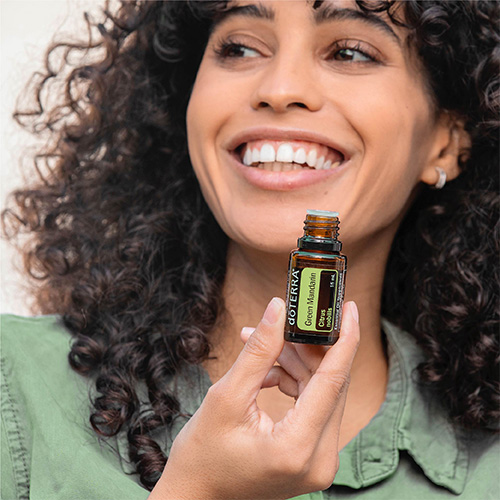 Woman holding Green Mandarin Essential Oil