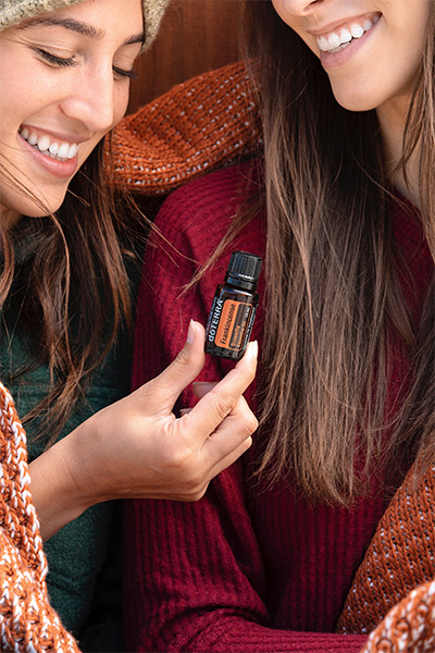 Woman holding Frankincense Essential Oil