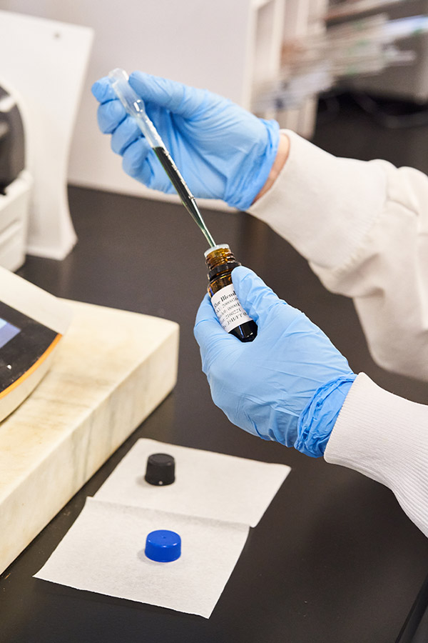 A scientist testing essential oil purity