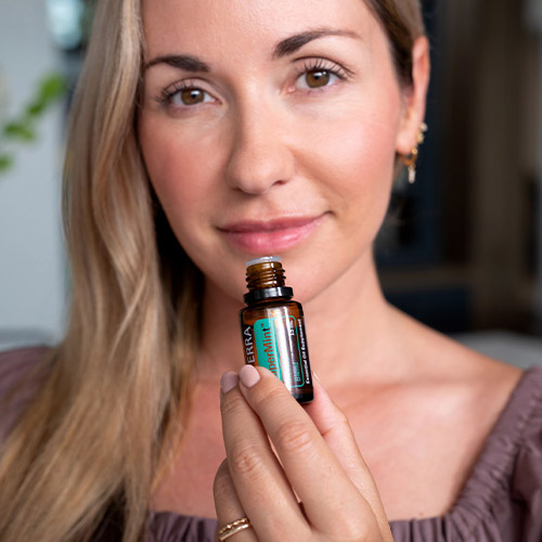Woman holding the essential oil SuperMint