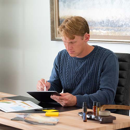 A man sitting at a table with a tablet