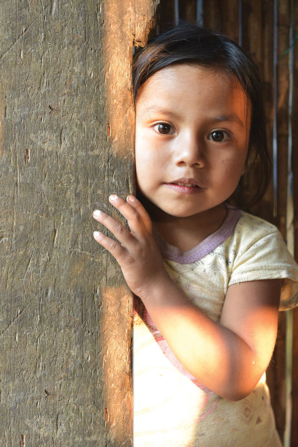 Little girl staring our the door