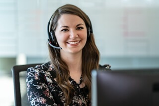 A woman sitting at a desk with a headset on