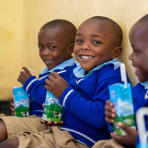 Children drinking from juice boxes