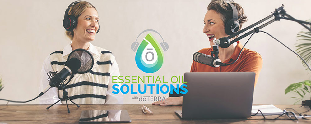 Two women talking on a microphone with the words essential oil solutions