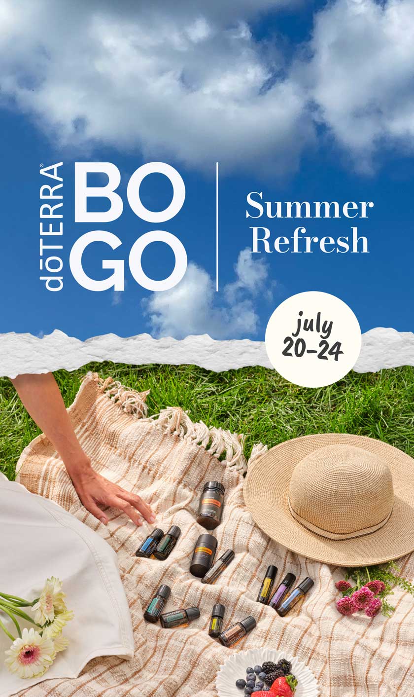 d&omacr;TERRA BOGO Summer Refresh, July 20&ndash;24 &mdash; essential oils arranged on a picnic blanket in the grass with a sun hat and fresh berries