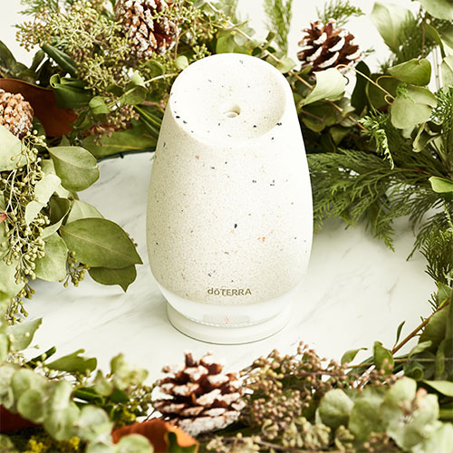 Roam diffuser sits on top of a wreath of greenery.